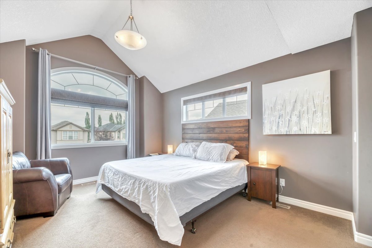 13 Cranberry Avenue SE Calgary primary bedroom with vaulted ceiling