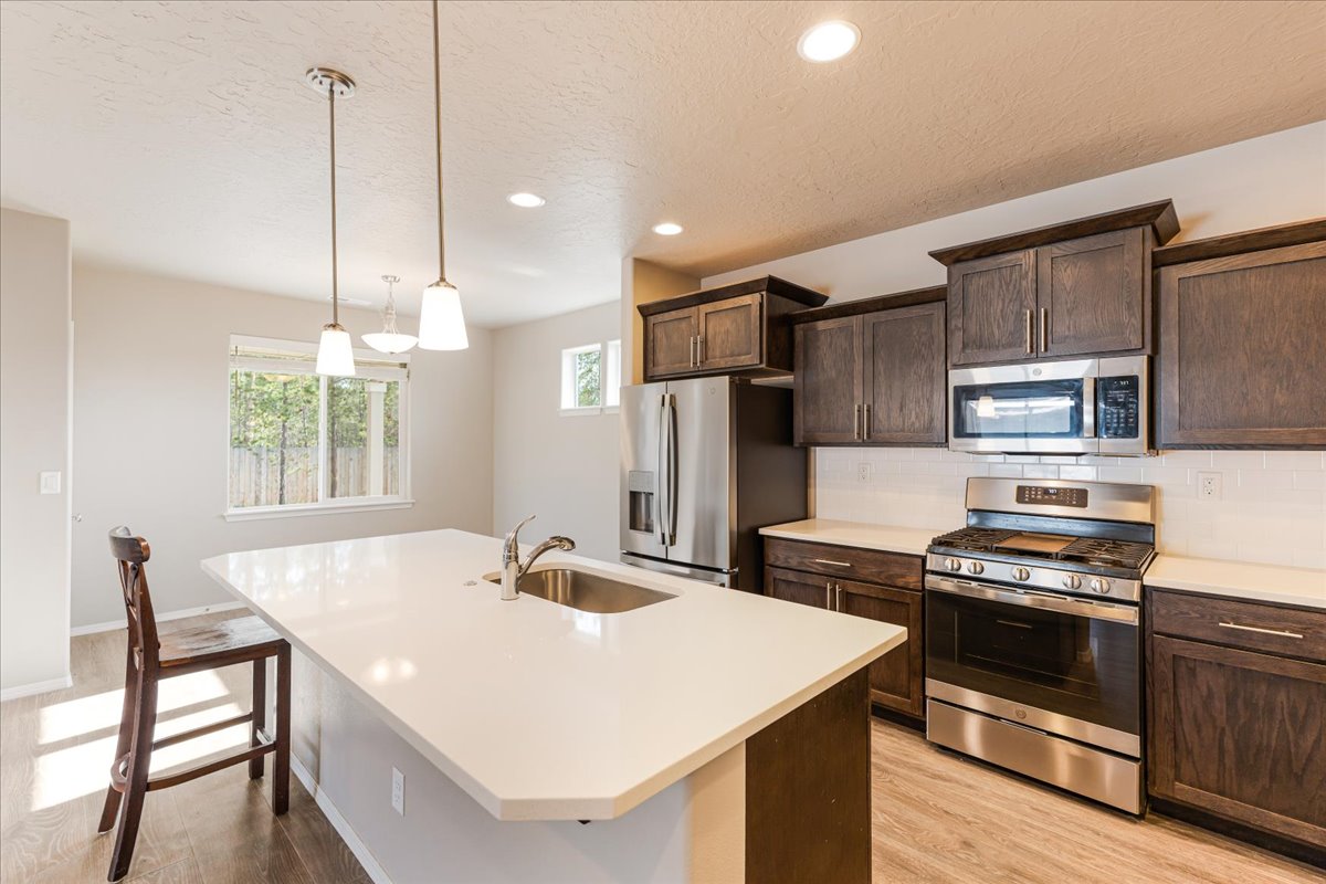 Modern kitchen with stainless steel appliances and beautiful cabinetry light up a kitchen with granite countertops. Modern kitchen with stainless steel appliances and beautiful cabinetry light up a kitchen with granite countertops.