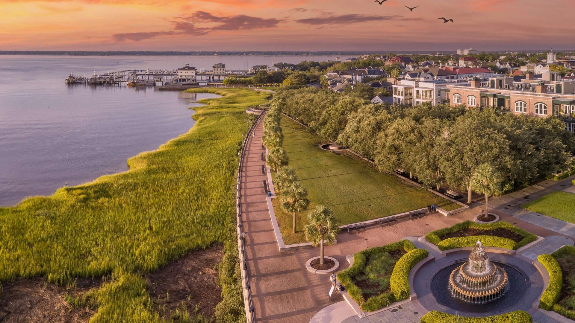 Aerial view of Charleston waterfront homes, the Battery, and surrounding marsh