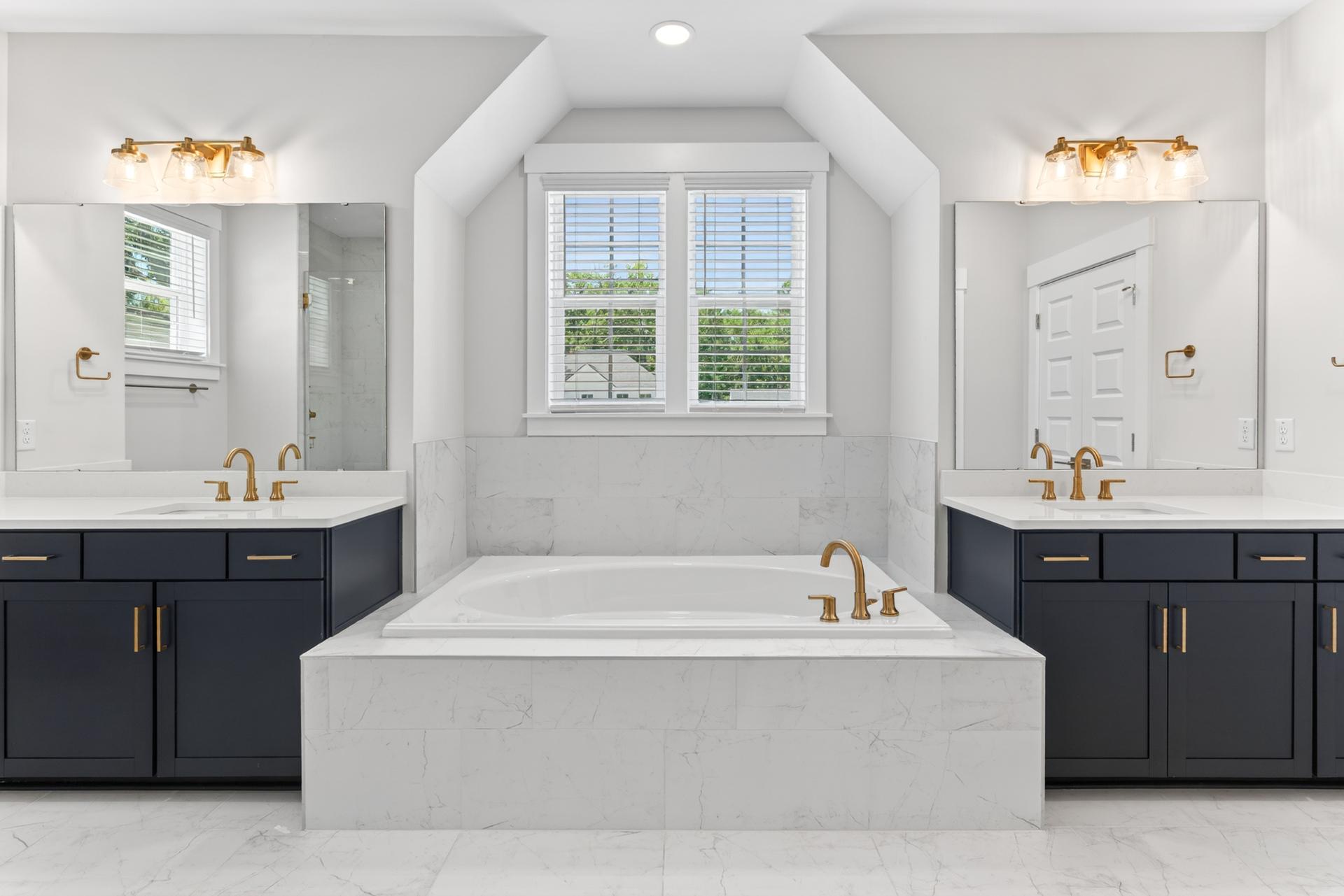 Primary bathroom with separate vanities and soaking tub