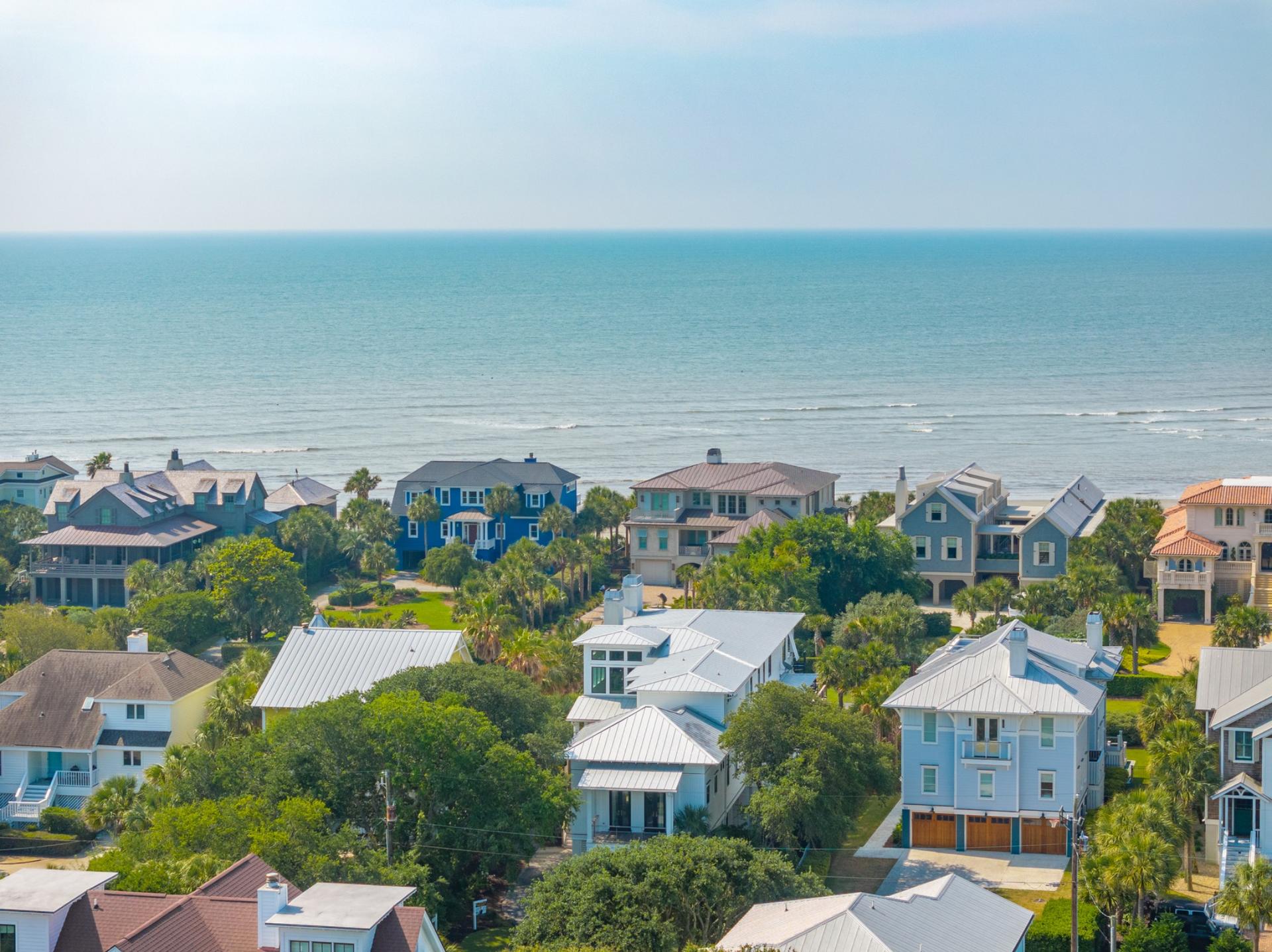 Charleston coastal homes overlooking a wide lawn at sunset