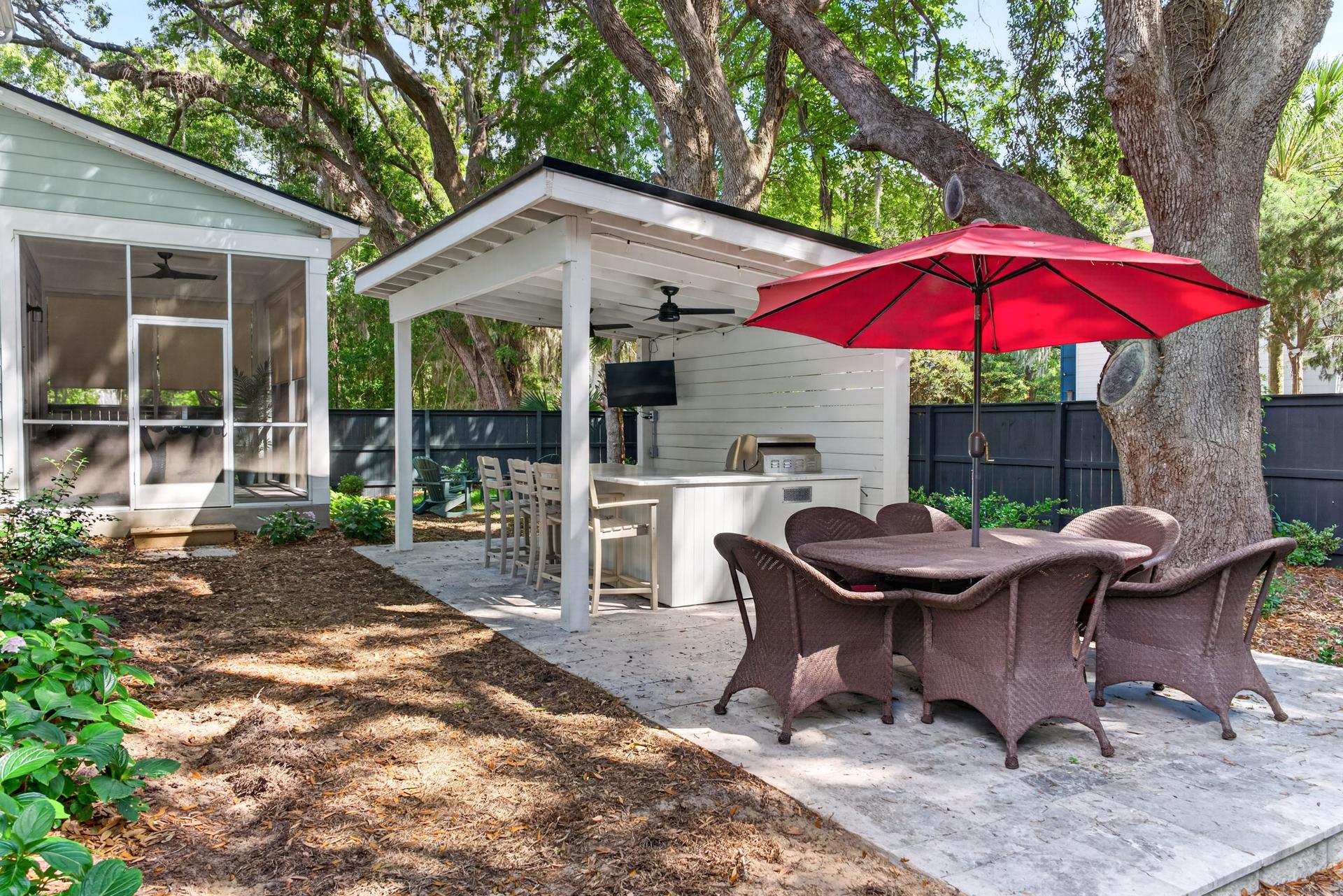 Fenced backyard shaded by mature trees