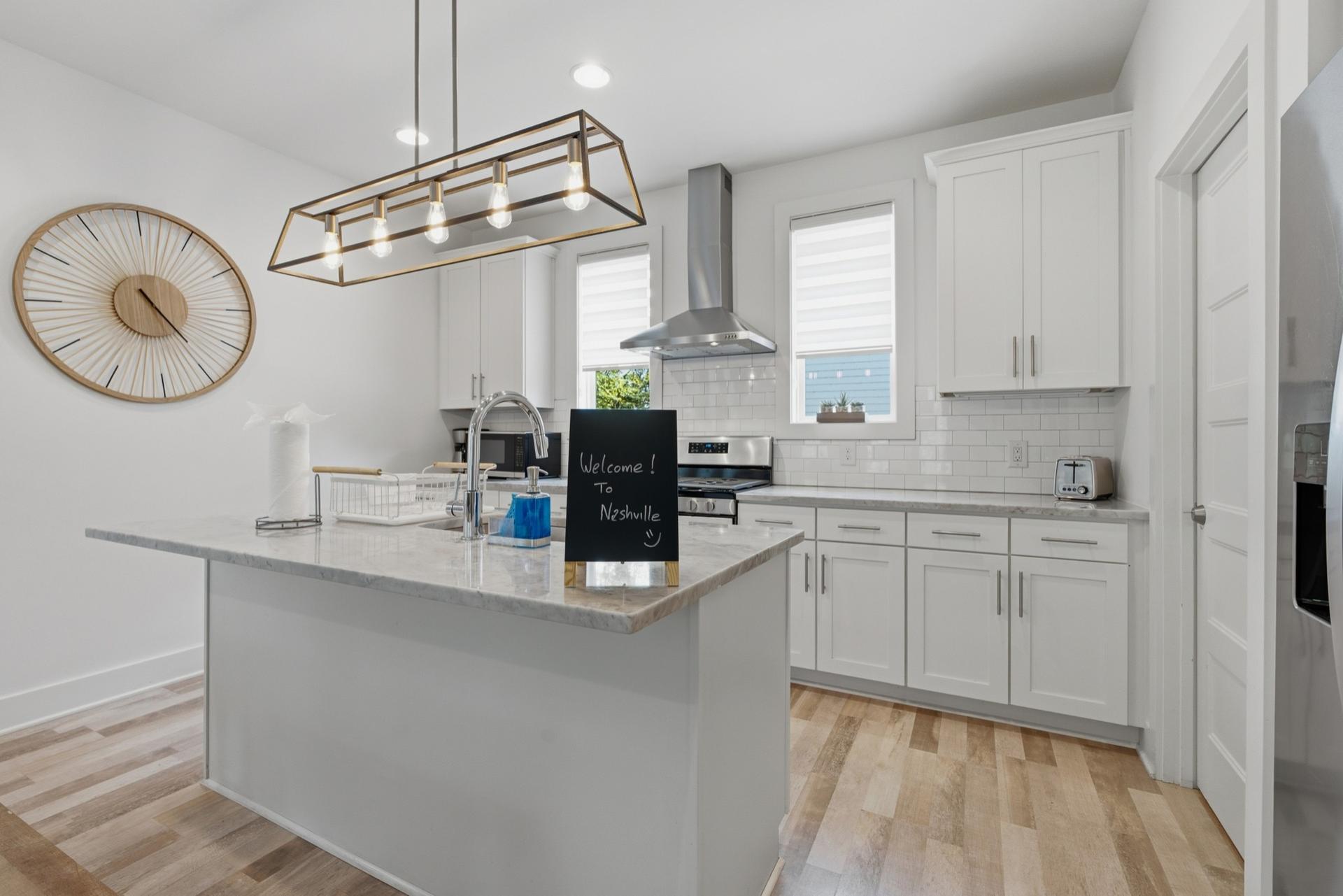 Kitchen with subway tile backsplash and stainless appliances