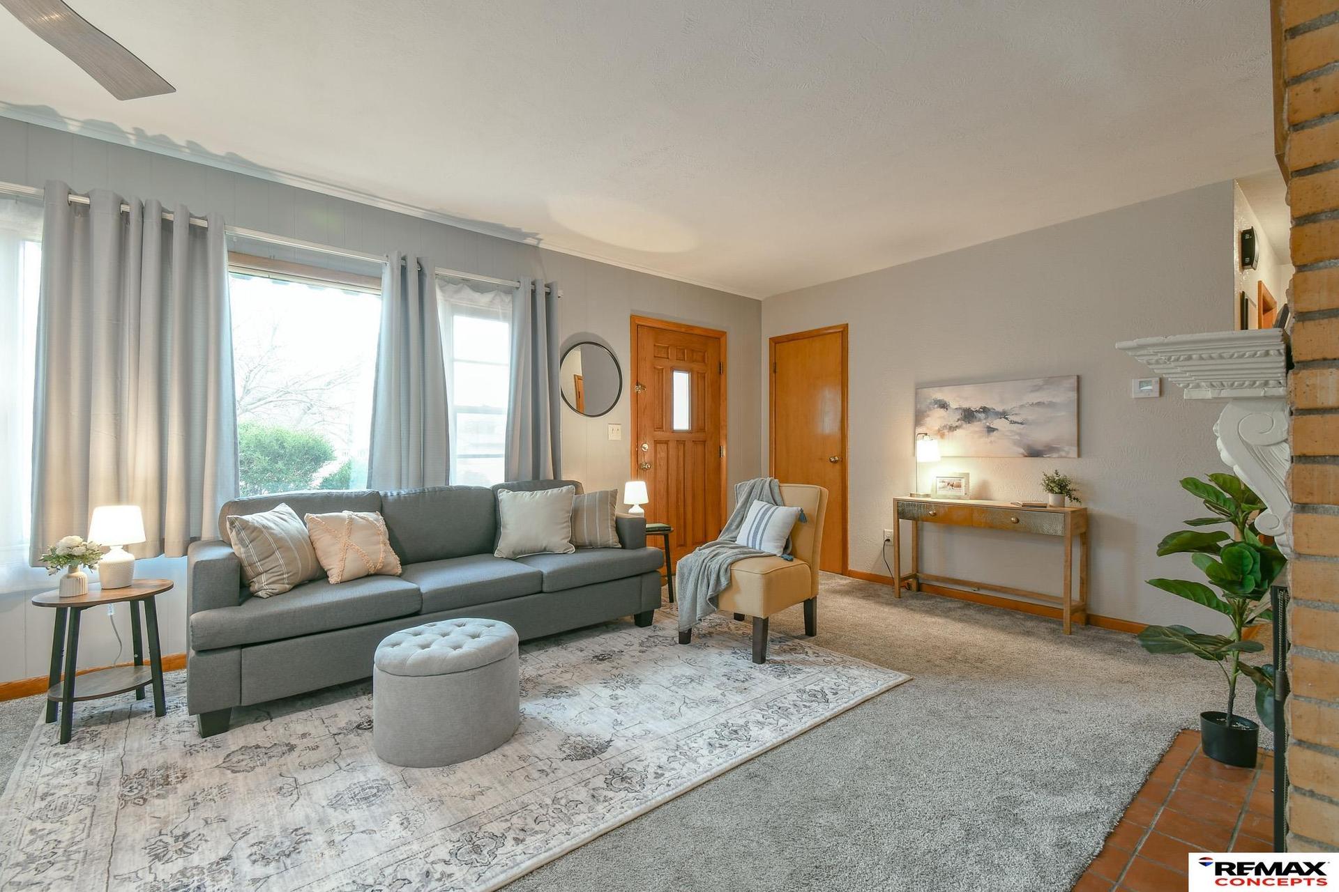 Living room after full-service staging with furniture, rug, lighting and decor
